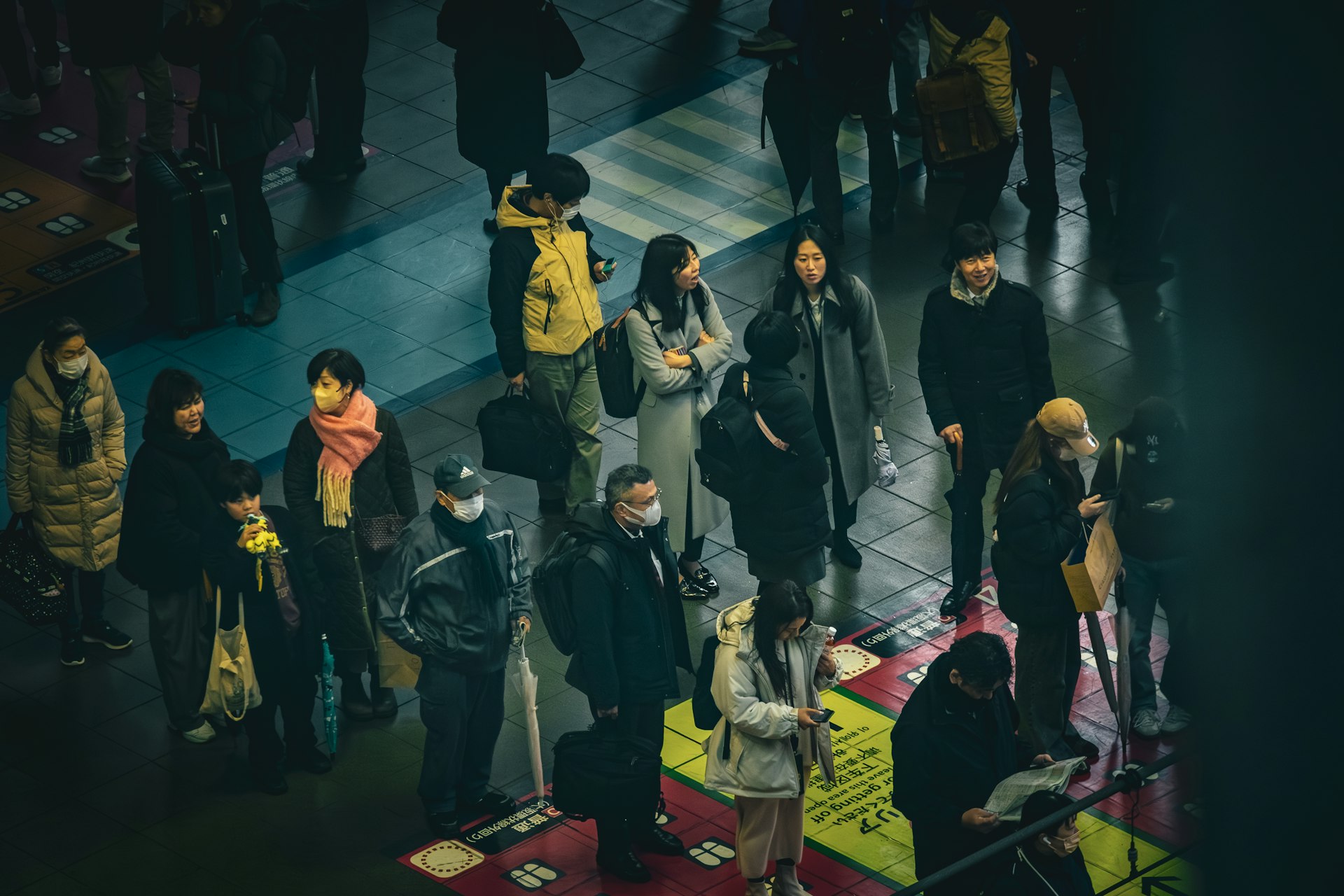 A crowd of people standing around each other