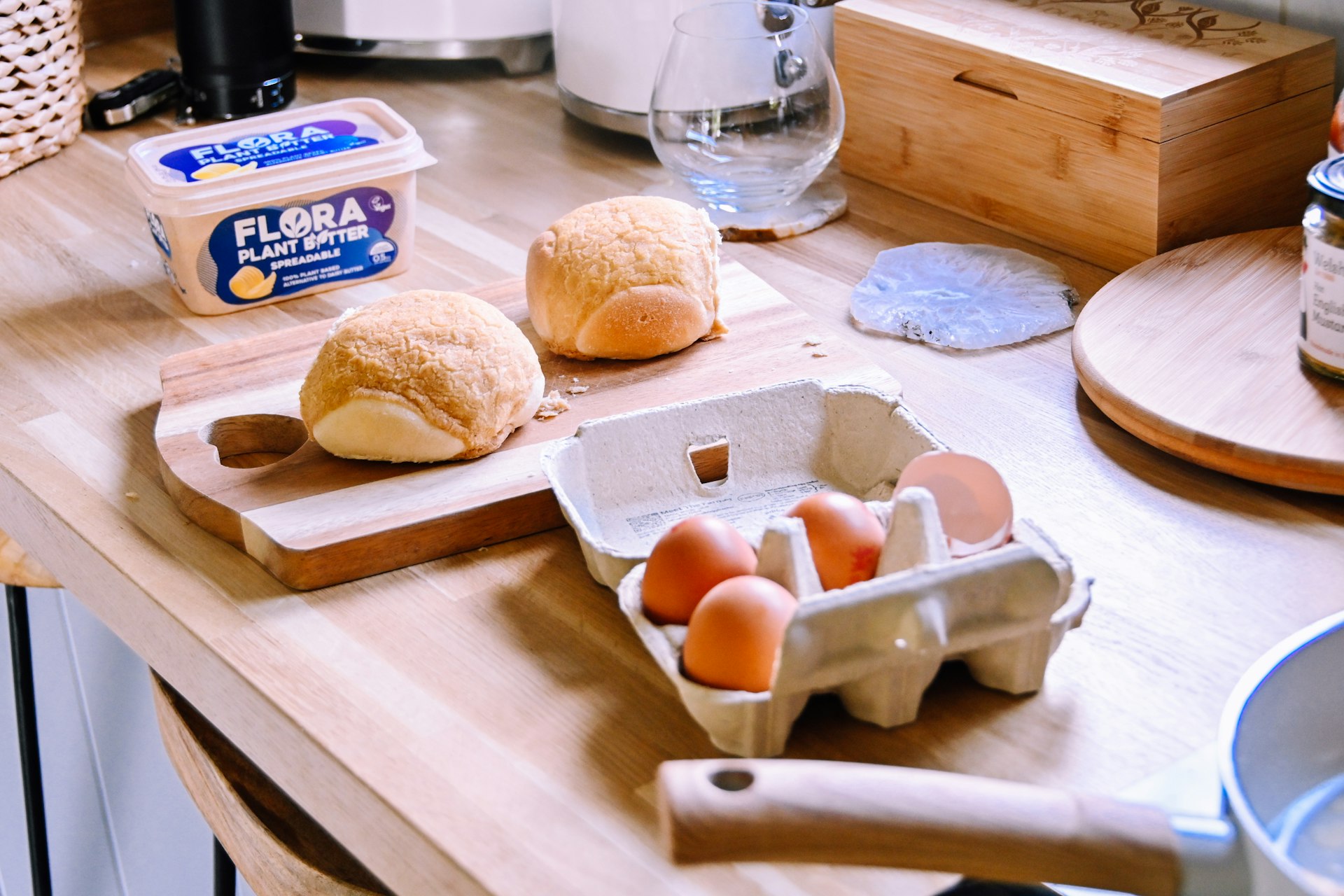a wooden table topped with eggs and bread